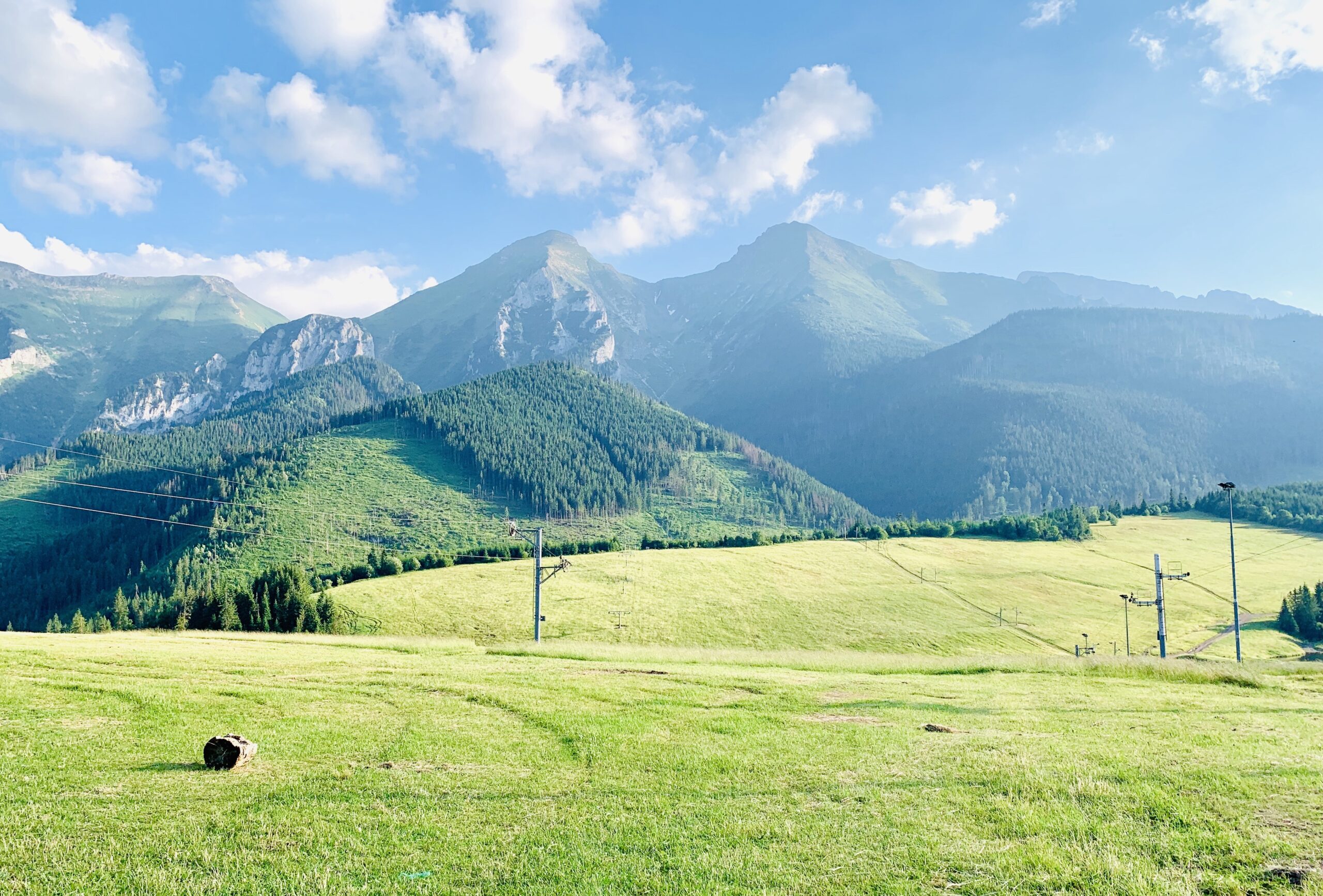 Sunlit meadow and mountain view symbolizing grounding and calm — Lumara Integrative Health.
